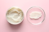 Natural scrub in Petri dish and jar of cosmetic product on pink background, flat lay