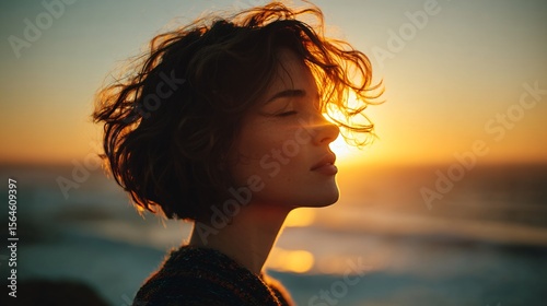 Artistic Portrait of Woman with Wavy Hair Against Sunset Glow