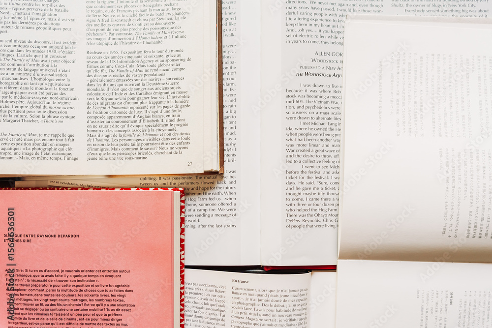 Fototapeta premium Open books arranged flat and shot from above. Focus on paper texture and typography. Educational and aesthetic