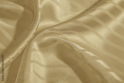 Smooth, elegant golden silk fabric with a flowing, shiny texture creates a luxurious backdrop