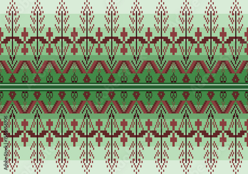 A vibrant green and brown textile pattern with geometric and floral motifs. This symmetrical design blends traditional elements and a digital pixel style, inspired by nature and cultural symbolism.