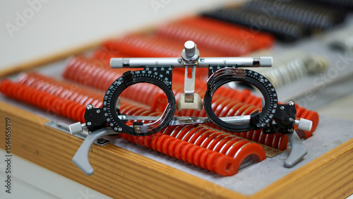 Close-up of a trial lens set with trial frame used for eye exams in optometry, showing various corrective lenses in a professional eye clinic. Lenses for precise vision testing and correction