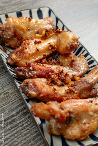 A view of a plate of garlic chicken wings.