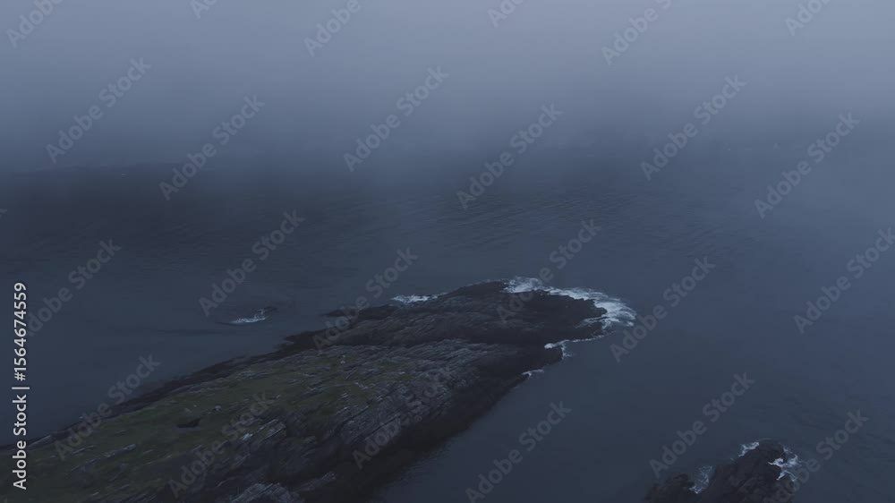 Misty Northern Norway Coastline: Rocky Islet and Overcast Ocean Horizon