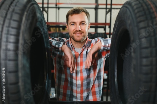 Man chooses winter car tires in the auto shop