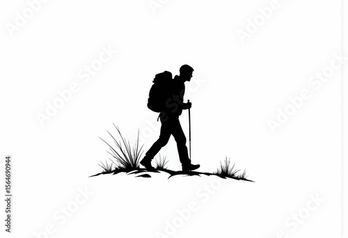 Silhouette of a hiker walking on grass with backpack and trekking poles  