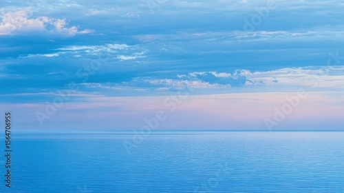Wallpaper Mural Calm blue sea meets the horizon under a soft pastel sky, creating a serene seascape Torontodigital.ca