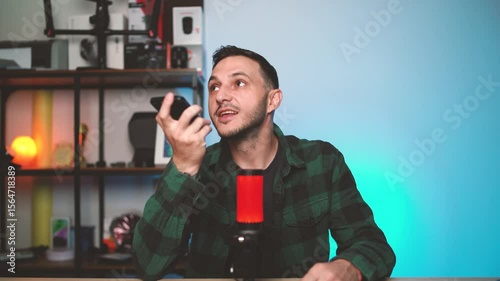 Man Speaking to AI Assistant on Smartphone While Holding It Near His Face at Home