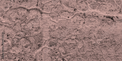 Texture of a cracked concrete surface depicting detailed cracks and imperfections with a dusty rose color aesthetic perfect for backgrounds