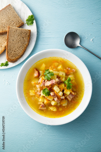 Traditional pea soup with smoked bacon