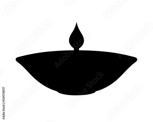 Black silhouette of a traditional Diwali oil lamp with flame burning