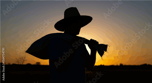 Silhouette of farmer with hat and tool against a sunset sky in a rural agricultural setting landscape
