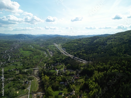 Fototapeta Naklejka Na Ścianę i Meble -  Budowa drogi ekspresowej S1 między Węgierską Górką a Milówką widziana z drona w wiosenny dzień. Construction of the S1 expressway between Węgierska Górka and Milówka captured by drone on a spring day 