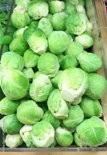 Fresh brussels sprout piled on the market stall.