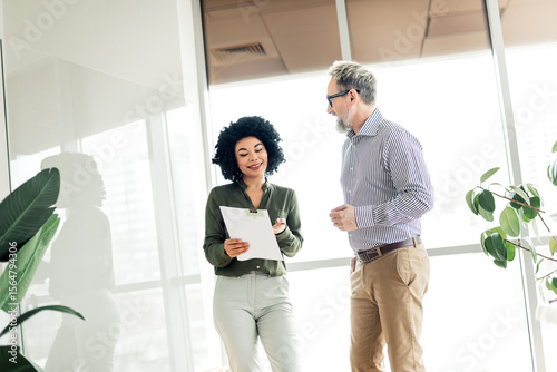 Professional teamwork displaying collaboration in a modern office environment with diverse coworkers engaging in a business meeting