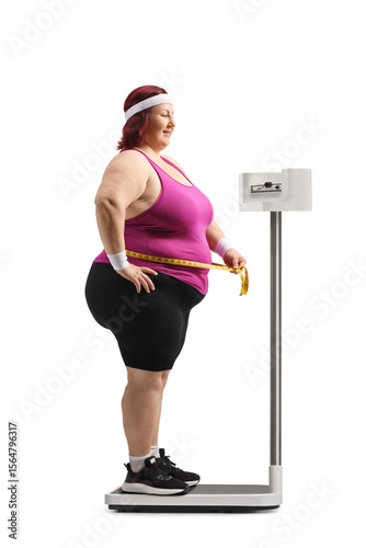 Fototapeta Plus size female checking wright on a scale