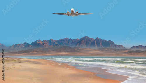 Old metallic propeller airplane in the sky, sunset clouds in the background - Namib desert with Atlantic ocean meets near Skeleton coast - Namibia, South Africa photo