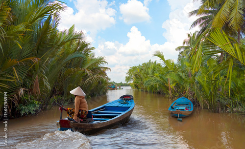 Fisherman is fishing in Mekong river in the morning - People boating in the delta of Mekong river, Vietnam, Asia