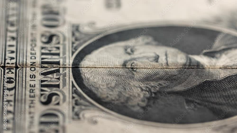 Macro static shot of various US dollar banknotes falling into frame
