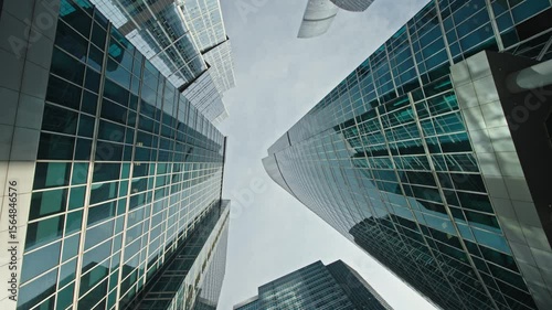 Moscow-City is famous International Business Center in Moscow, Russia. Beautiful wide angle view from below from a moving camera on tall skyscrapers buildings in a modern city business downtown.