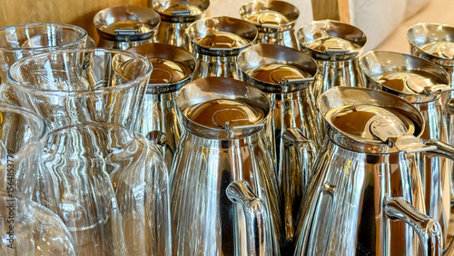 Valokuva Polished steel carafes glisten in morning light, echoing a symphony of reflectio