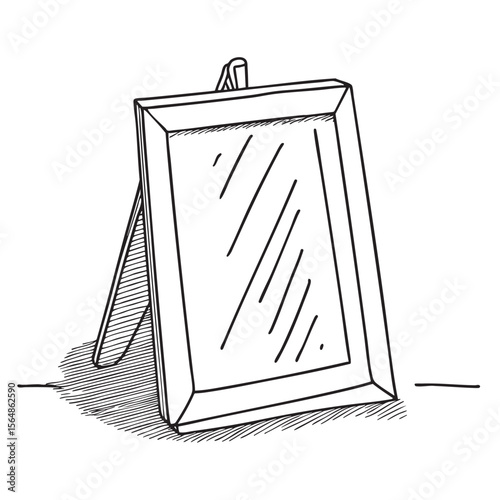 A picture frame leaning unevenly against the wall