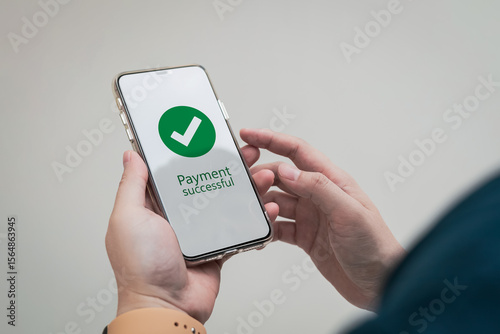 A successful payment notification message appears on the customer's smartphone screen when they make a payment via an online banking application.