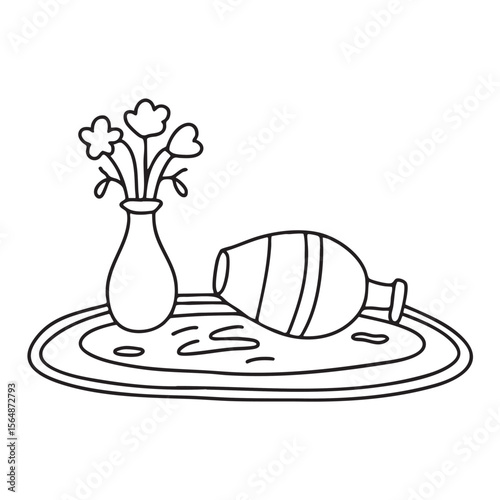 A vase turned sideways lying next to scattered flowers on the rug