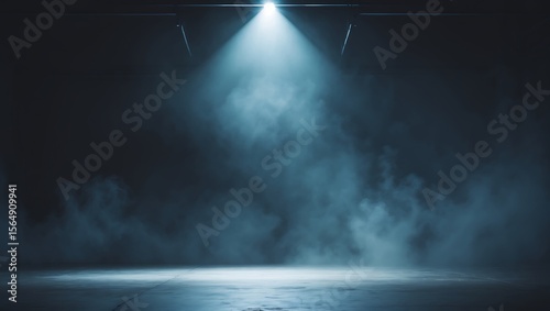 A single bright spotlight illuminates swirling blue smoke in a dark empty industrial space