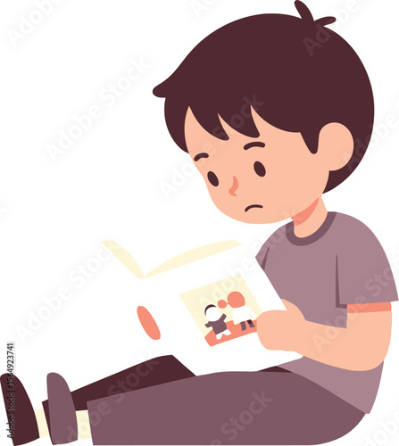 A boy sitting down reading a book with a picture on the cover art