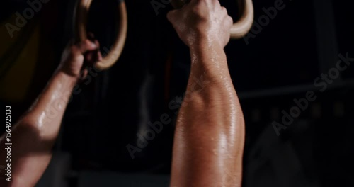 In a dim boxing ring, a determined man showcases his skills in an intense match