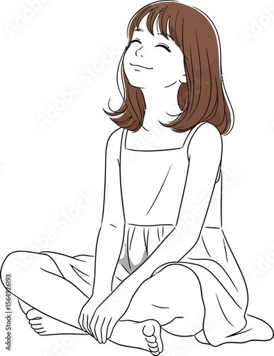 A girl sitting cross legged in a dress looking upwards with a smile