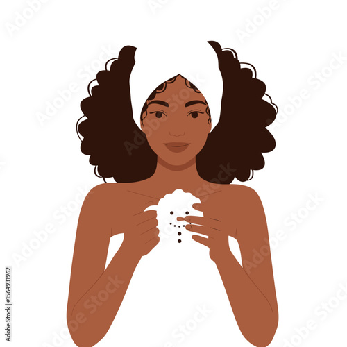 Young black woman drinking hot cocoa with marshmallows in a New Year's mug