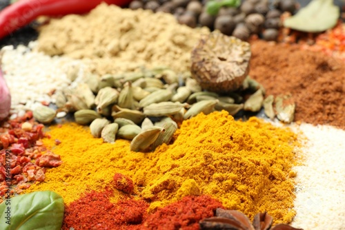 Fototapeta Naklejka Na Ścianę i Meble -  Different aromatic spices as background, closeup view