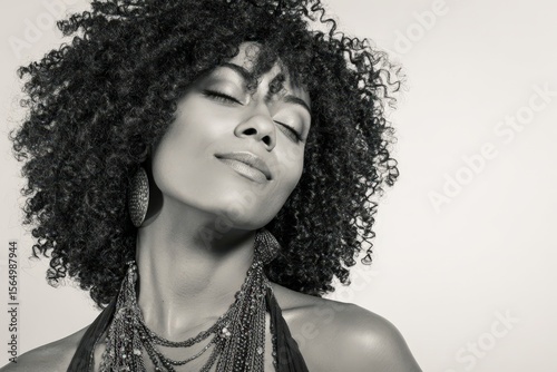 Elegant black and white portrait of a woman with curly hair. Perfect for fashion, beauty, and haircare marketing. Ideal for websites, magazines, and social media.
