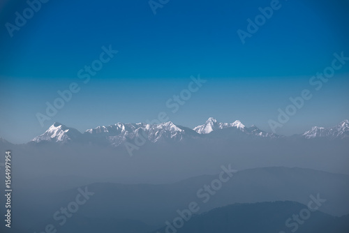 Panoramic View of White Snow Kumaon Himalaya Range notable peaks being Trishul, Nanda Devi, Nanda Kot, as seen from Uttarakhand
