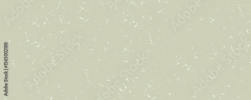 A speckled, neutral-toned background with small, curved white marks scattered across the surface.