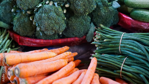 Fresh Farm Vegetables at Market Stall: Carrots, Broccoli, and Green Beans
