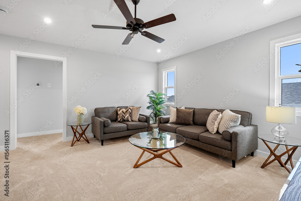Fototapeta premium Living room with a brown couch and a glass coffee table