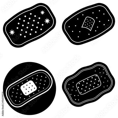 Four black and white bandages in different shapes and designs with white dots and center patches
