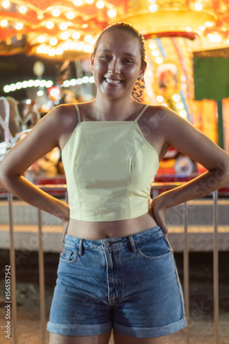 Smiling young woman enjoying a night at the carnival