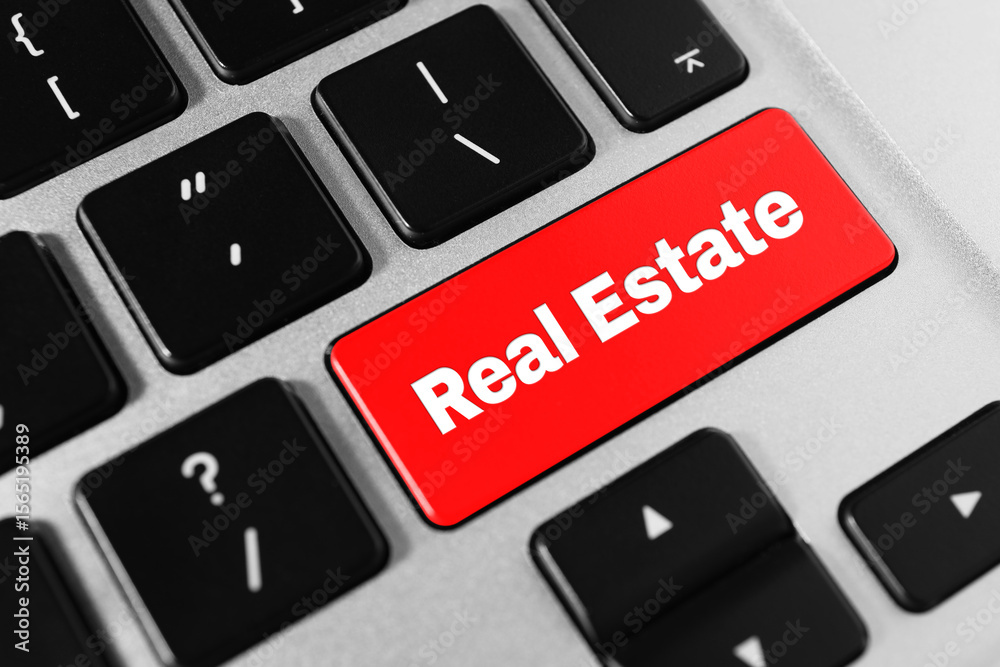 Online accommodation search. Button with words Real Estate on computer keyboard, closeup Online accommodation search. Button with words Real Estate on computer keyboard, closeup