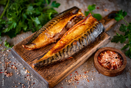 Billede på lærred Smoked mackerel on a board. Smoked fish for lunch. Close-up