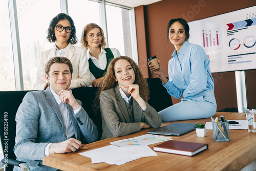 Group of business professionals collaborating in a modern office setting showcasing teamwork and cooperation