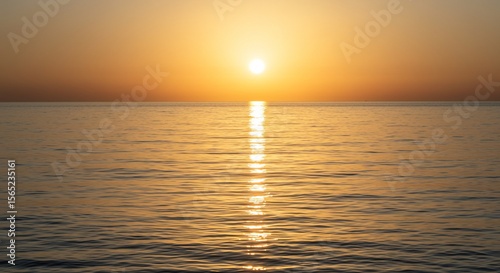 Golden Sunset Reflecting on Calm Ocean Water with Bright Sun and Horizon