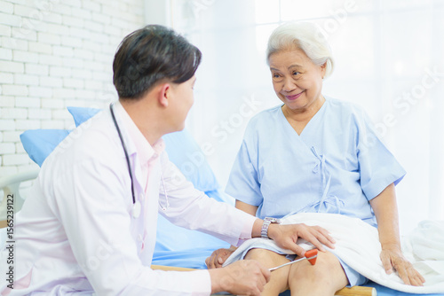 Orthopedic doctor checking on elderly woman knee.