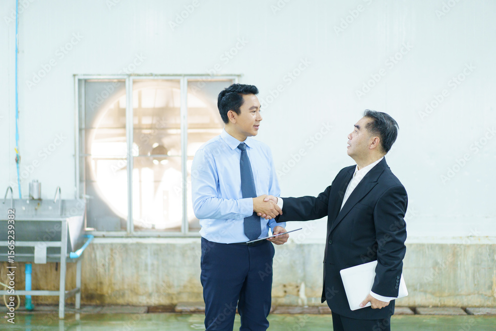Fototapeta premium Businessman or engineer walking and observing around food production factory.