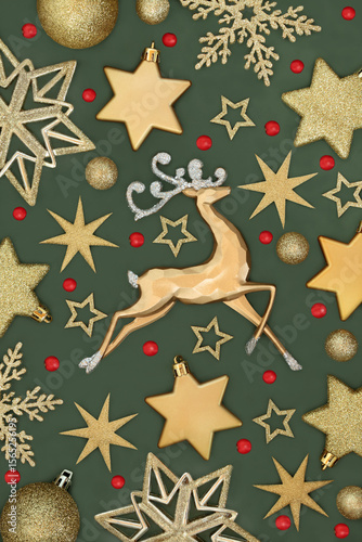 Wallpaper Mural Christmas gold tree decorations with reindeer, red holly berries, star, snowflake, sphere ball shape baubles. Xmas background festive theme on green. Torontodigital.ca