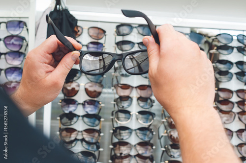 Hands Choosing Sunglasses from Retail Display Fashion, Vision, Shopping