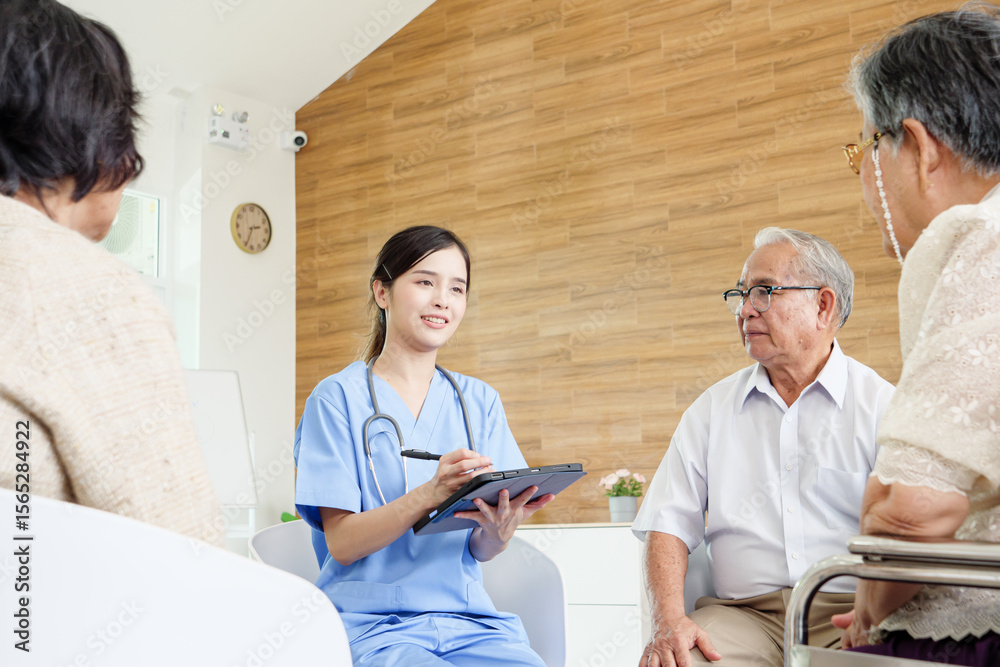 Obraz premium Professional Southeast Asian nurse consulting elderly patients in bright modern care facility, using laptop for health advice, symbolizing quality senior healthcare, trust, and compassion.